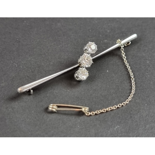 230 - A white metal diamond three stone bar brooch, set graduated brilliant cut stones, totalling approxim... 