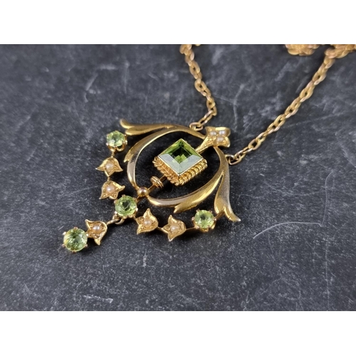 230A - An Art Nouveau yellow metal peridot and pearl pendant necklace, stamped '9ct', 37cm.... 