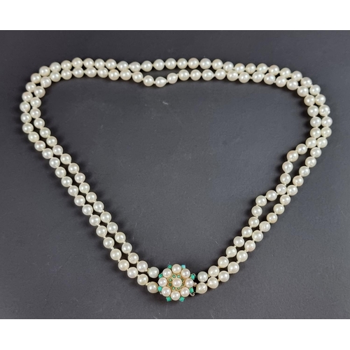 232 - A cultured pearl two strand necklace, the pearls of uniform size and fastened by a 9ct gold circular... 