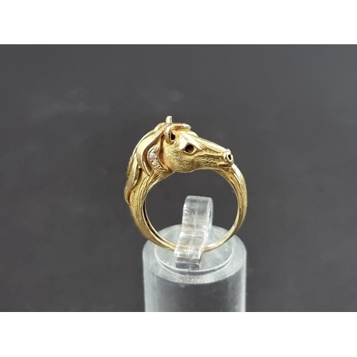 234 - A Garrard & Co 18ct gold stylised horse head ring, set cabochon ruby eye and six diamonds to man... 