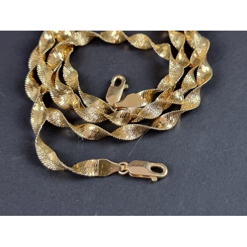 242 - A textured yellow metal spiral link necklace, stamped '585' and '14k', 45cm; together with a matchin... 