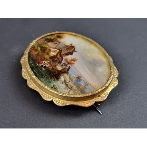 243 - A gold plated brooch, inset mother-of-pearl panel painted with anglers, 6cm wide.