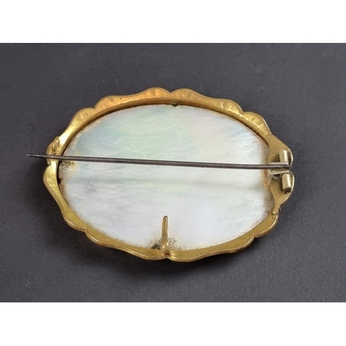 243 - A gold plated brooch, inset mother-of-pearl panel painted with anglers, 6cm wide.