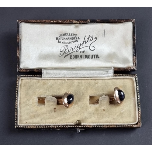 245 - A pair of yellow metal and cabochon sapphire cufflinks, stamped '585'.