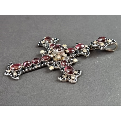 248 - A 19th century parcel gilt Bohemian pendant cross, having enamel decoration, set with cabochon garne... 