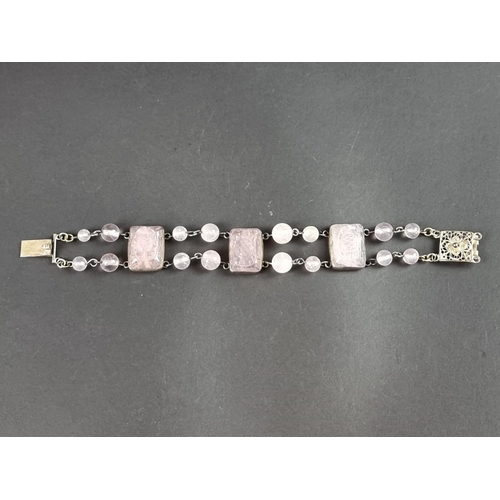 249 - A vintage bracelet, set three carved rose quartz panels, interspersed with sixteen rose quartz beads... 