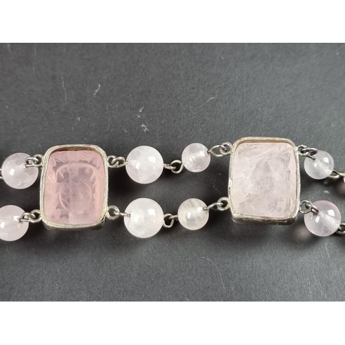 249 - A vintage bracelet, set three carved rose quartz panels, interspersed with sixteen rose quartz beads... 