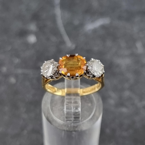 254 - A yellow sapphire and diamond three stone ring, set sapphire and two brilliant cut diamonds of appro... 