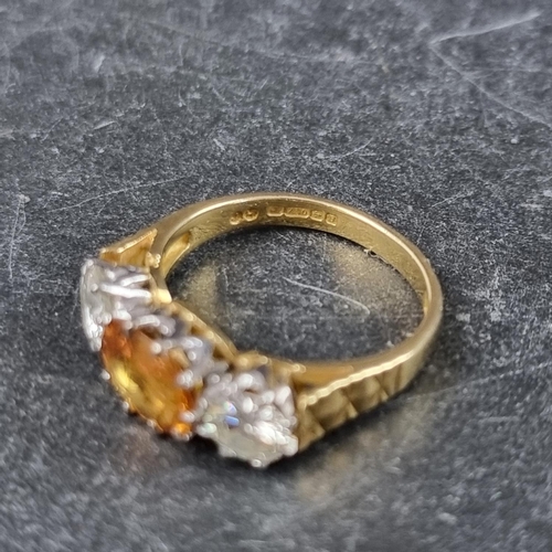 254 - A yellow sapphire and diamond three stone ring, set sapphire and two brilliant cut diamonds of appro... 