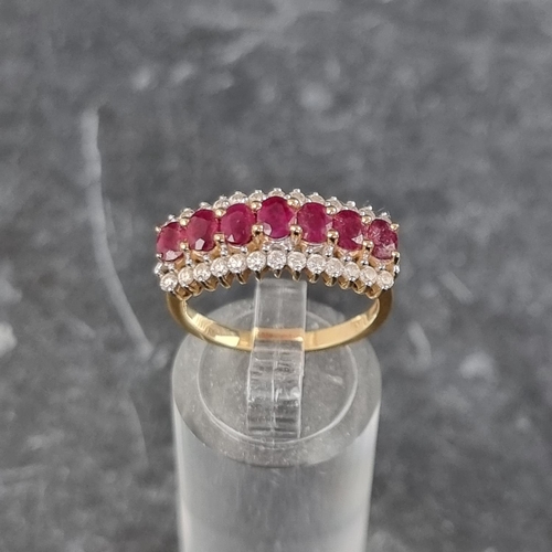 255 - An 18ct gold ruby and diamond ring, set seven faceted rubies with thirteen diamonds to either side, ... 