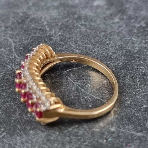 255 - An 18ct gold ruby and diamond ring, set seven faceted rubies with thirteen diamonds to either side, ... 