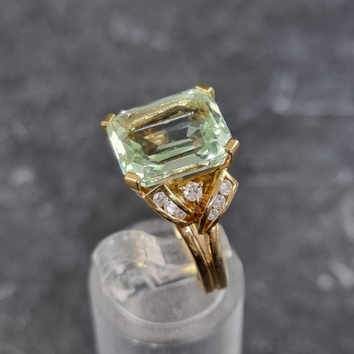 256 - An aquamarine and diamond ring, set rectangular cut cornered aquamarine with seven brilliant cut dia... 