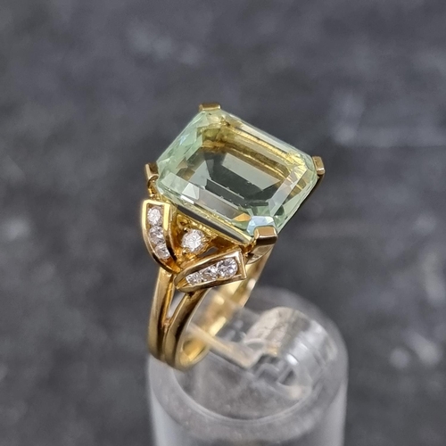 256 - An aquamarine and diamond ring, set rectangular cut cornered aquamarine with seven brilliant cut dia... 