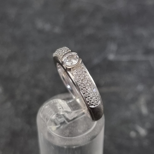 258 - An 18ct white gold ring, set brilliant cut diamond of approximately 0.25ct and multiple pave set sma... 