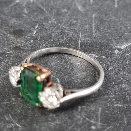 268 - An emerald and diamond three stone ring, set emerald of approximately 1.3ct and two brilliant cut di... 