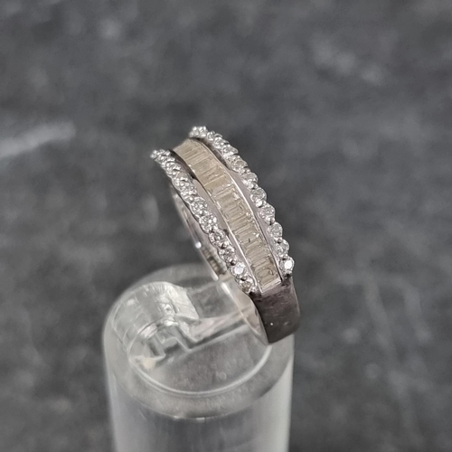 270 - An 18ct white gold diamond half eternity ring, set with a row of eighteen channel set baguette diamo... 