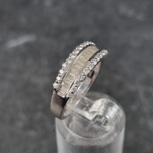 270 - An 18ct white gold diamond half eternity ring, set with a row of eighteen channel set baguette diamo... 