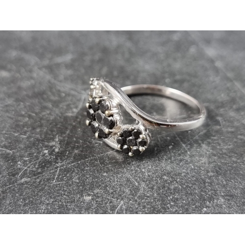 294 - A 9ct white gold ring, set three clusters of black diamonds, totalling 1ct, size P, gross weight 3.4... 