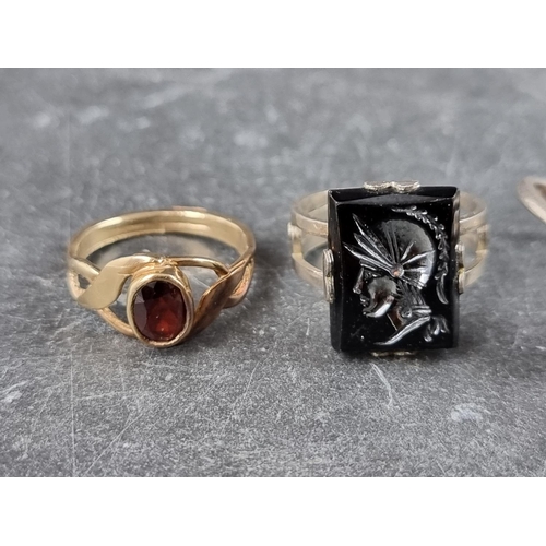 295 - A yellow metal garnet ring, size L1/2; together with three other rings. (4)