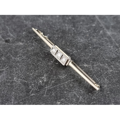 298 - An Art Deco style diamond three stone bar brooch, stamped '18k', 53mm.