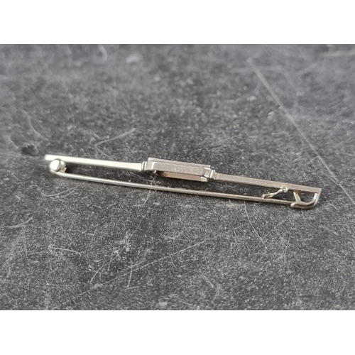 298 - An Art Deco style diamond three stone bar brooch, stamped '18k', 53mm.