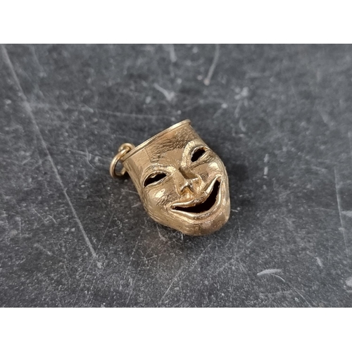 305 - A 9ct gold 'comedy' & 'tragedy' mask pendant, hallmarked London 1965, 21mm high, 7.2g.... 