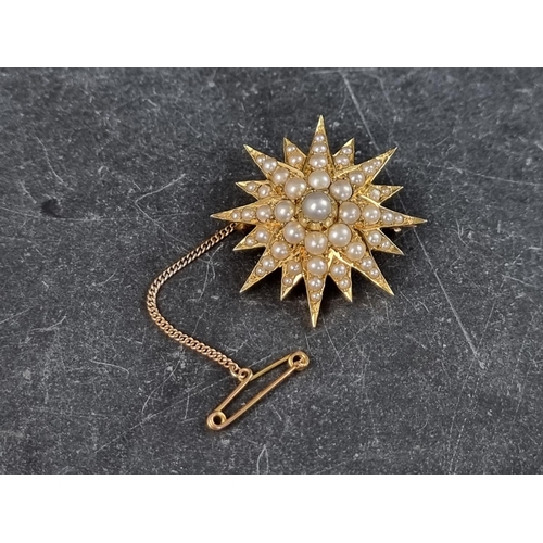 306 - A Victorian yellow metal starburst brooch, set split pearls, 34mm diameter.