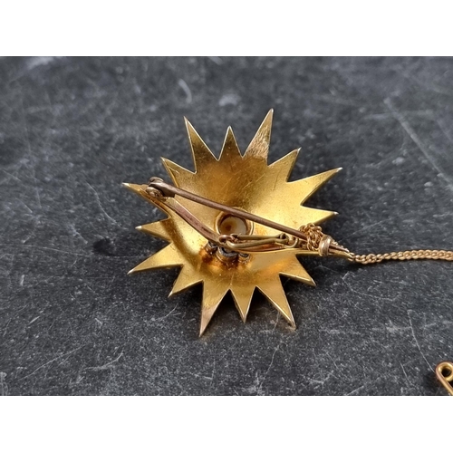 306 - A Victorian yellow metal starburst brooch, set split pearls, 34mm diameter.