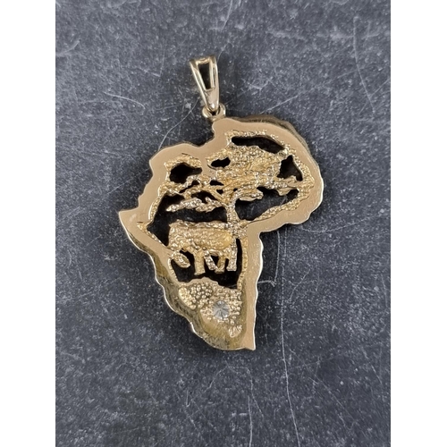 309 - A yellow metal 'Africa' pendant, set diamond, stamped '14k,' 35mm high.