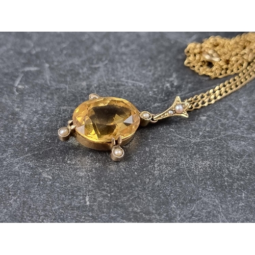 310 - An early 20th century yellow metal pendant, set faceted citrine and split pearls, 32mm high; on 9ct ... 