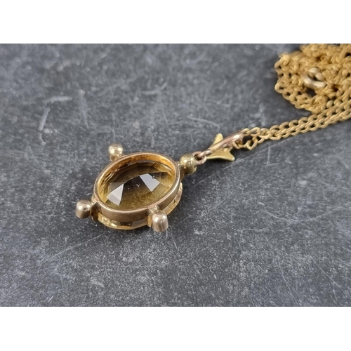 310 - An early 20th century yellow metal pendant, set faceted citrine and split pearls, 32mm high; on 9ct ... 