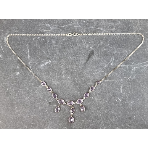 312 - A white metal necklace, having thirteen faceted pink topaz, stamped '925', approximately 42.5cm long... 