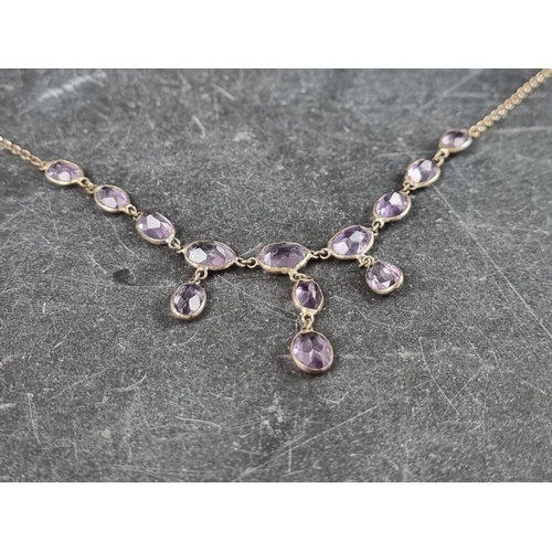 312 - A white metal necklace, having thirteen faceted pink topaz, stamped '925', approximately 42.5cm long... 