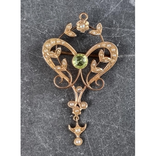 320 - An Edwardian pearl and peridot floral scroll brooch pendant, 48mm high.