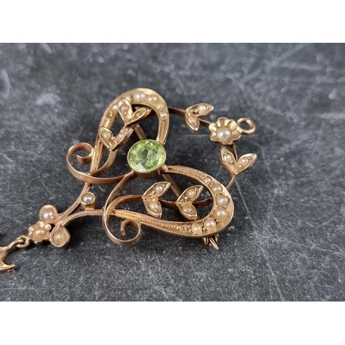 320 - An Edwardian pearl and peridot floral scroll brooch pendant, 48mm high.