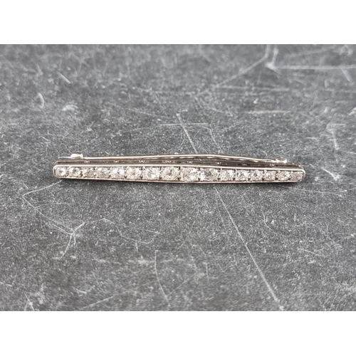 327 - An early 20th century white metal bar brooch, set sixteen graduated old cut diamonds, 55mm.... 