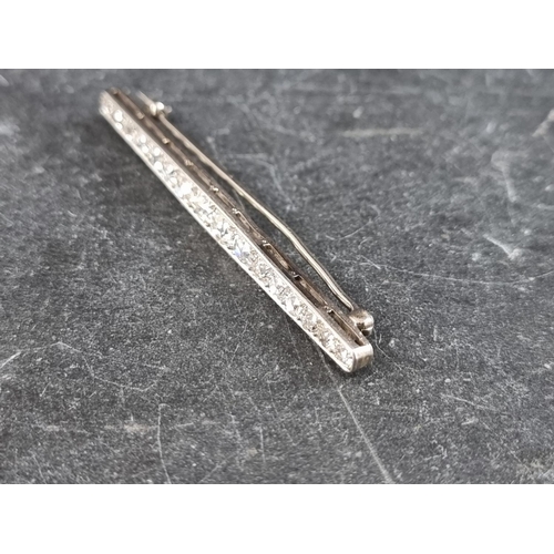 327 - An early 20th century white metal bar brooch, set sixteen graduated old cut diamonds, 55mm.... 