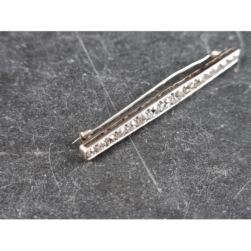 327 - An early 20th century white metal bar brooch, set sixteen graduated old cut diamonds, 55mm.... 