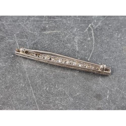 327 - An early 20th century white metal bar brooch, set sixteen graduated old cut diamonds, 55mm.... 