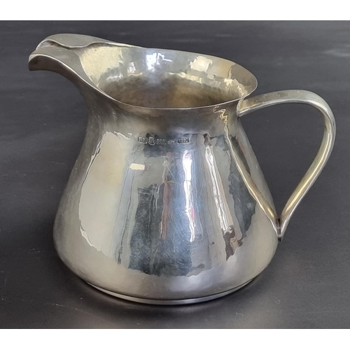 4 - A Continental hammered white metal jug, stamped '800', 12.5cm high, 436g.