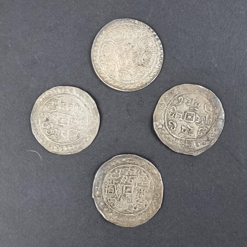 444 - Coins: four silver Tibetan tangka coins.