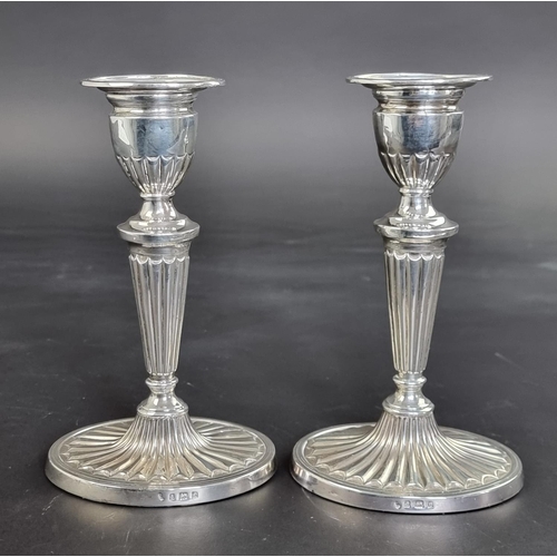 55 - A pair of Edwardian silver candlesticks, by Williams Ltd, Birmingham 1904, 17cm high, weighted.... 