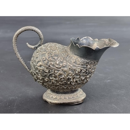 62 - An Eastern white metal cream jug, stamped '1.85', 9.5cm high.