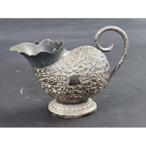 62 - An Eastern white metal cream jug, stamped '1.85', 9.5cm high.