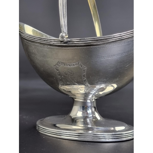 64 - A William IV silver swing handled sugar bowl, by Henry Chawner, London 1832, height to handle 1... 