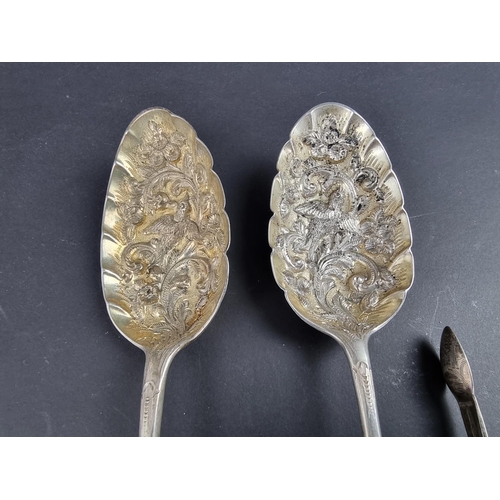 98 - A pair of late Victorian silver spoons, by I S, London 1901; together with two pairs of silver sugar... 