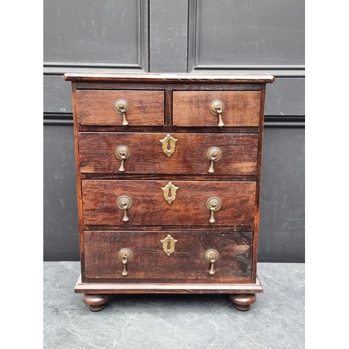 1003 - A miniature early 20th century oak chest of drawers, 50cm high x 39.5cm wide.