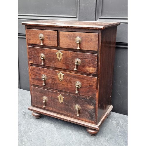 1003 - A miniature early 20th century oak chest of drawers, 50cm high x 39.5cm wide.