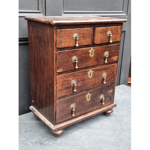 1003 - A miniature early 20th century oak chest of drawers, 50cm high x 39.5cm wide.