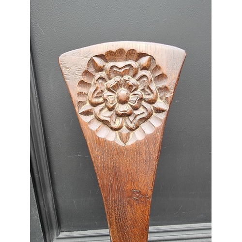 1064 - A carved oak spinning stool, by Jack Grimble, Cromer.